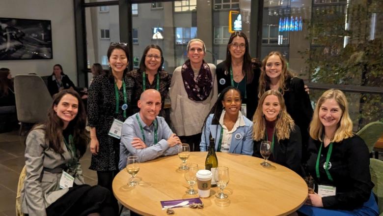 Carolyn Becker poses for a photo with some colleagues 和 former students